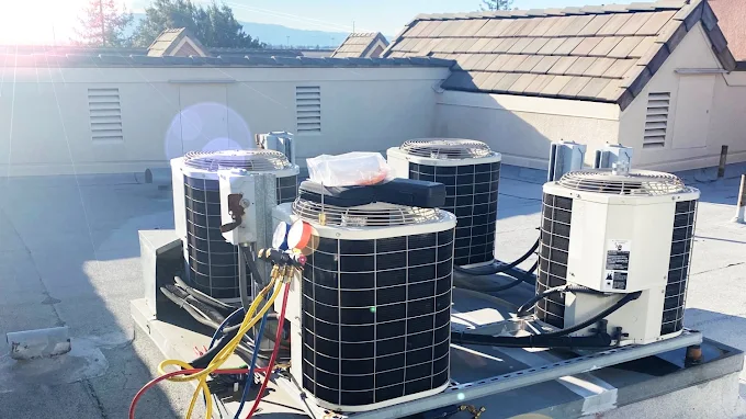 Rooftop commercial AC condenser units serviced by Perma